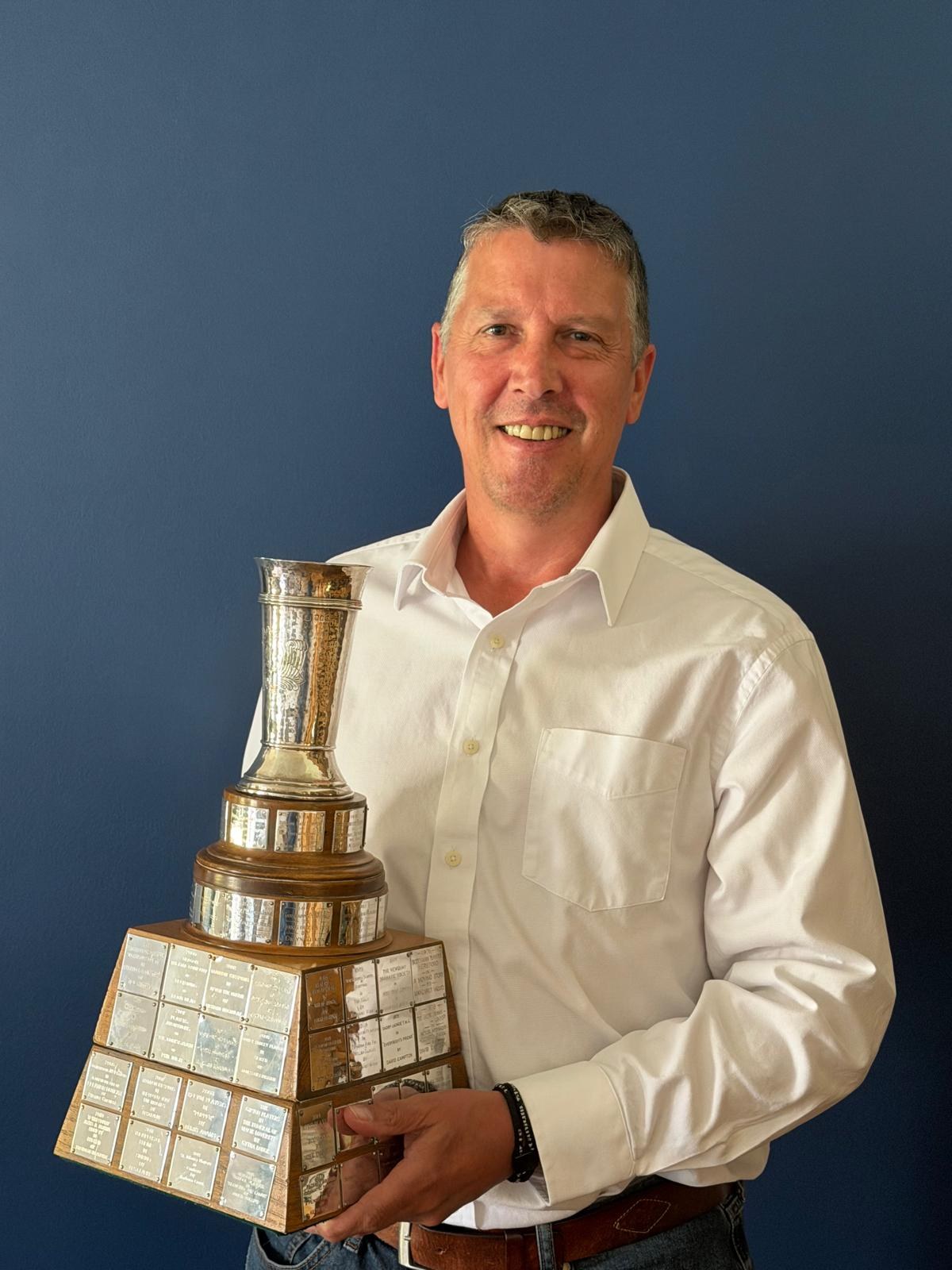 Keith Mackenzie holding the Geoffrey Whitworth Trophy